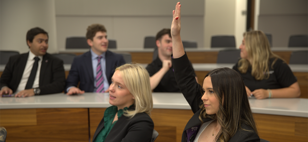 Section Image: Neeley leaders at a conference room table 