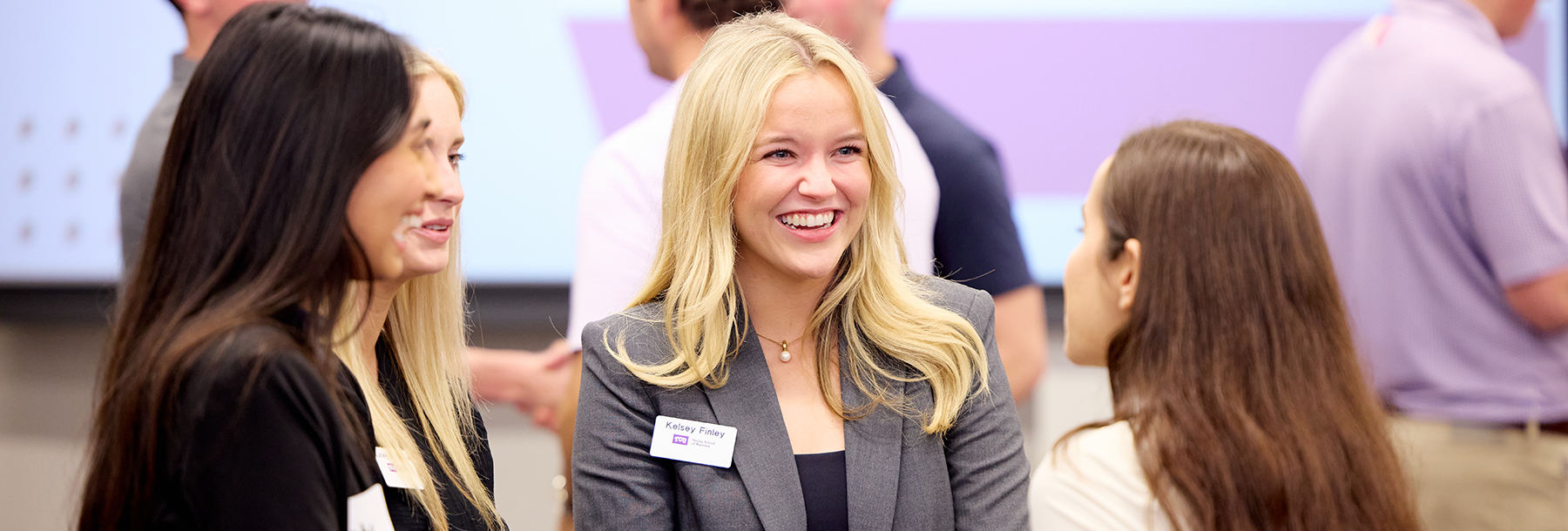 Section Image: Four women, two students and two employers, at a career fair 