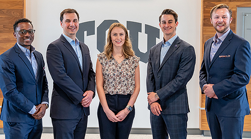 Group of five students in front of Shaddock Auditorium