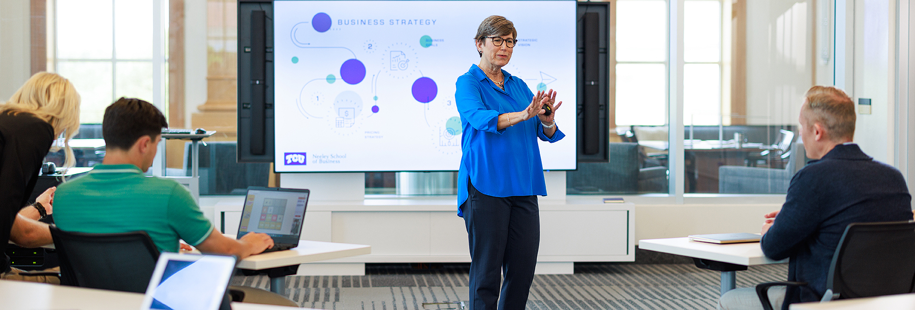 Section Image: Suzanne Carter addresses students in a classroom 