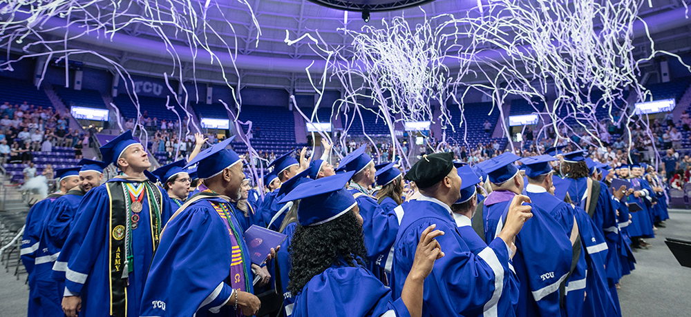 Section Image: Graduates watching as confetti rains down on them 