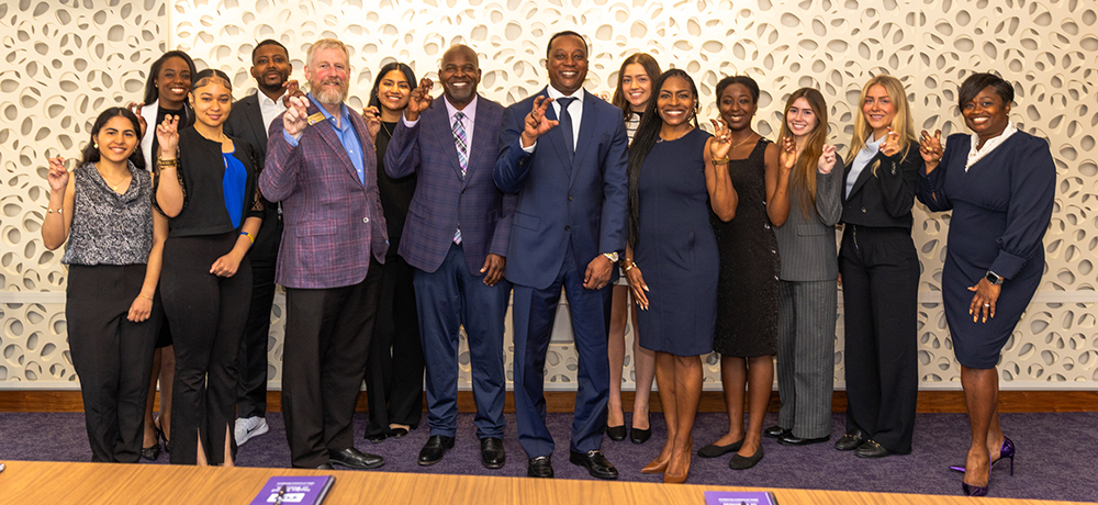 Students meet with Anthony Kyles and Dean Crossland in the Neeley boardroom