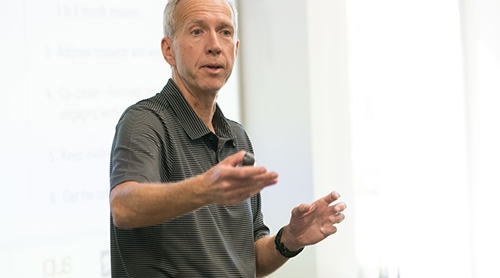 Texas Christian University Sign in front of the building with flowers 