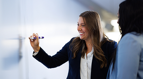 Woman writing on a white board
