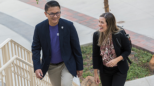 Man and woman coming up the outside stairs