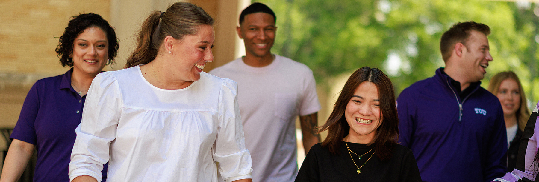 Section Image: Group walking outside between buildings 
