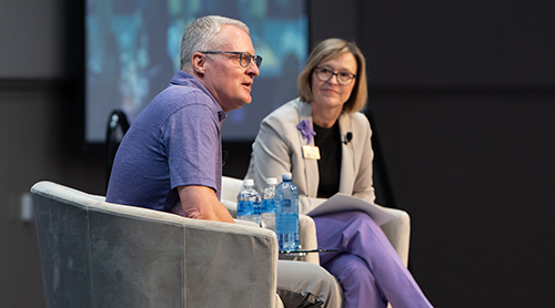 Section Image: Eric Artz and Hettie Richardson on the stage in the BLUU ballroom at the TESS event 
