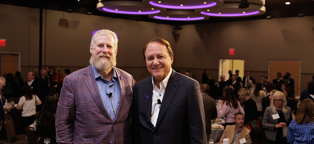 Craig Crossland and Jim Keyes with their backs to the audience in the BLUU ballroom