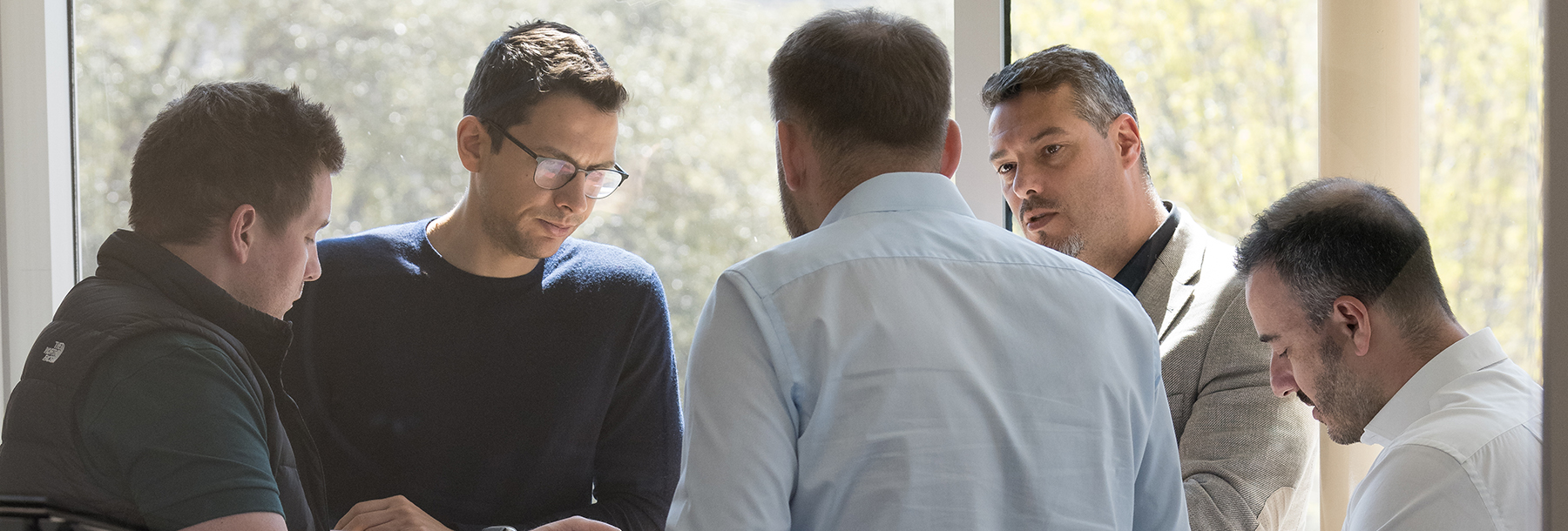 Group of men discussing around a table 