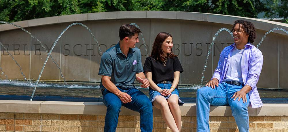 Group of TCU students on Neeley fountain
