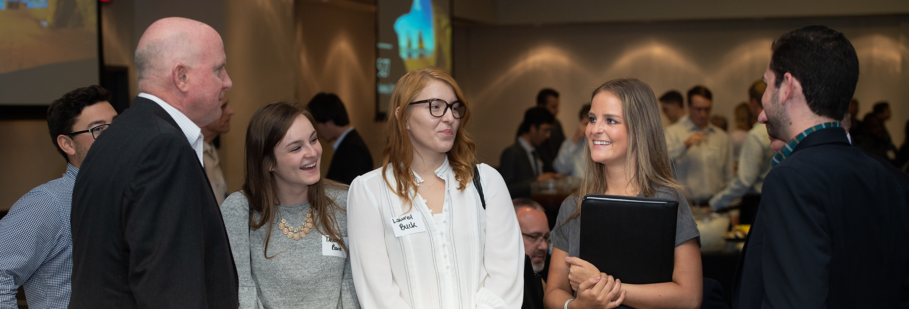 Section Image: Group of people mingling at a networking event 