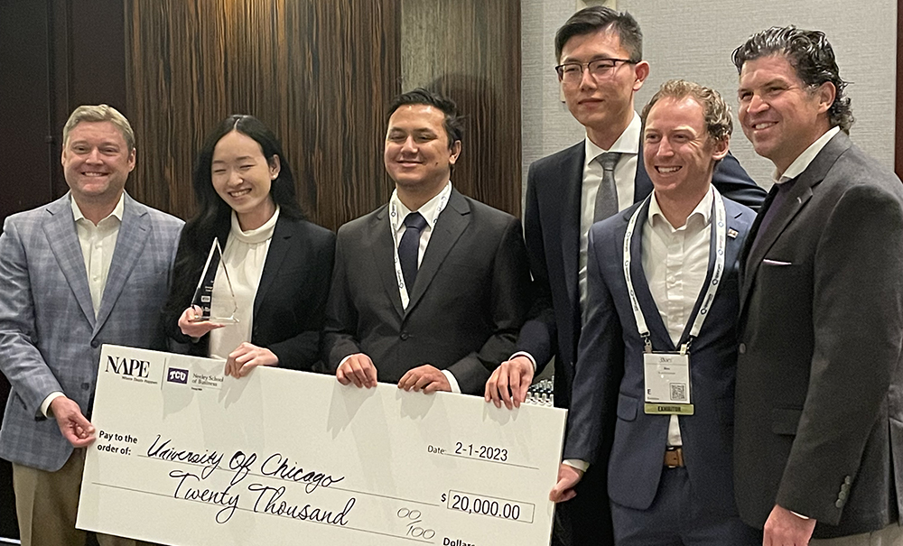 The winning team from the University of Chicago pose with Dean Pullin and an award check and trophy