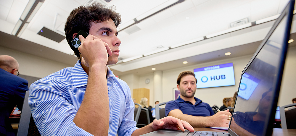 Student on the phone with a laptop
