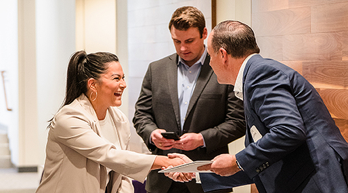 Man and woman shaking hands in the hallway