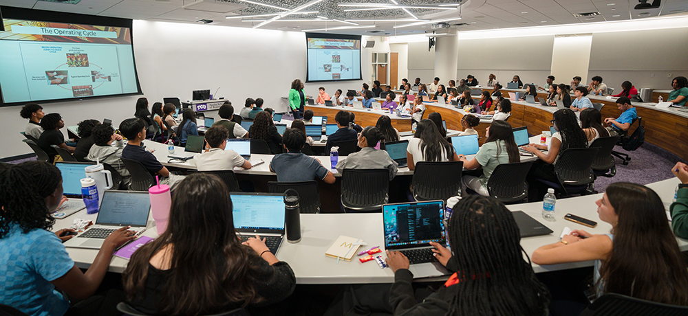 ACAP students listening to a presentation in a classroom