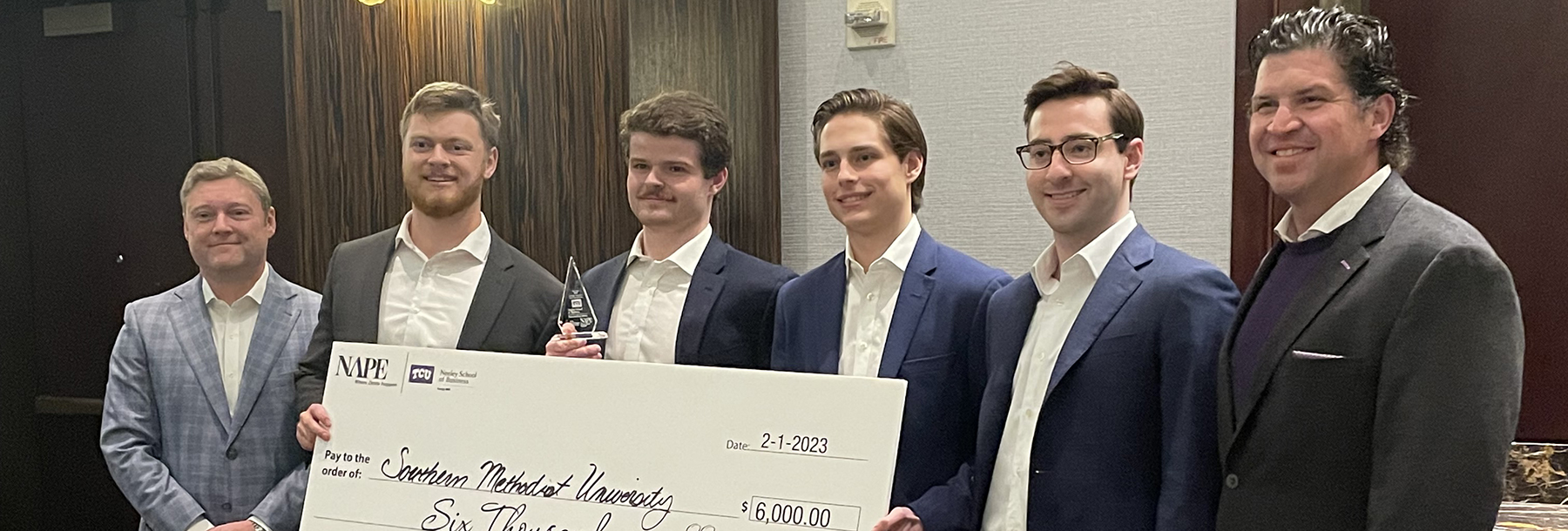 Section Image: Third place team from SMU display their trophy and award check alongside Jason Maloy and TCU President Daniel Pullin 