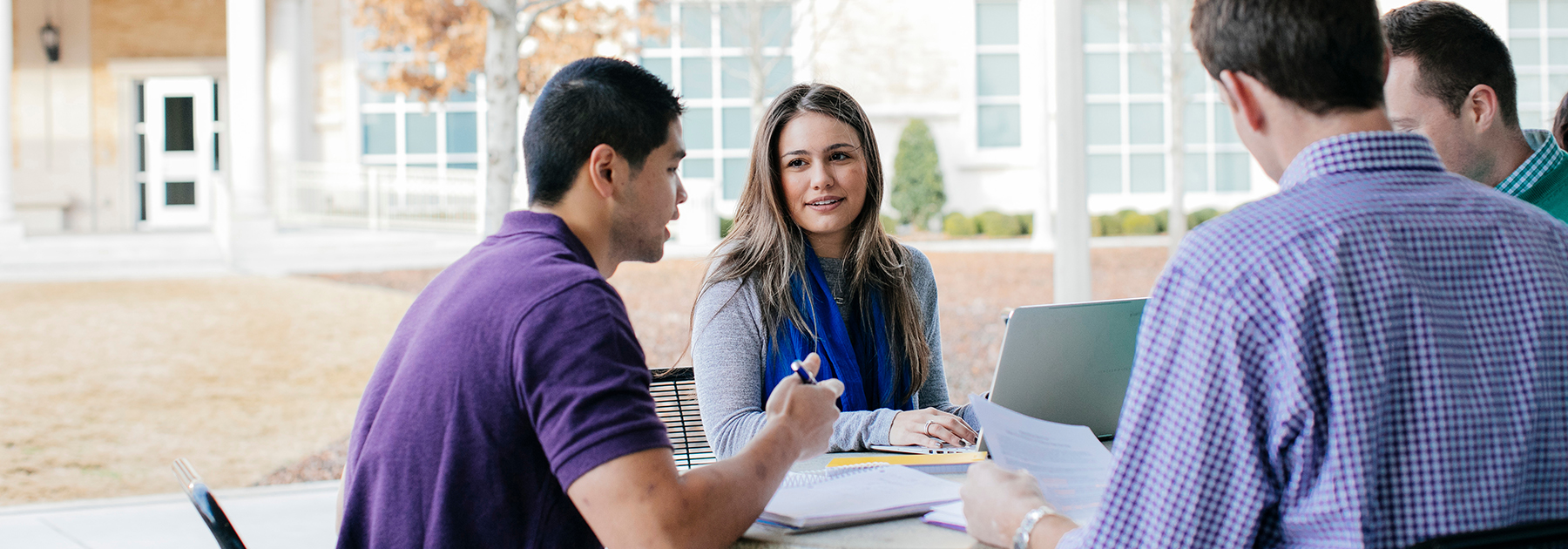 Section Image: Students at a table outside Smith Hall 