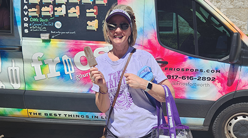 Section Image: Student with a table full of bags to hand out to families 